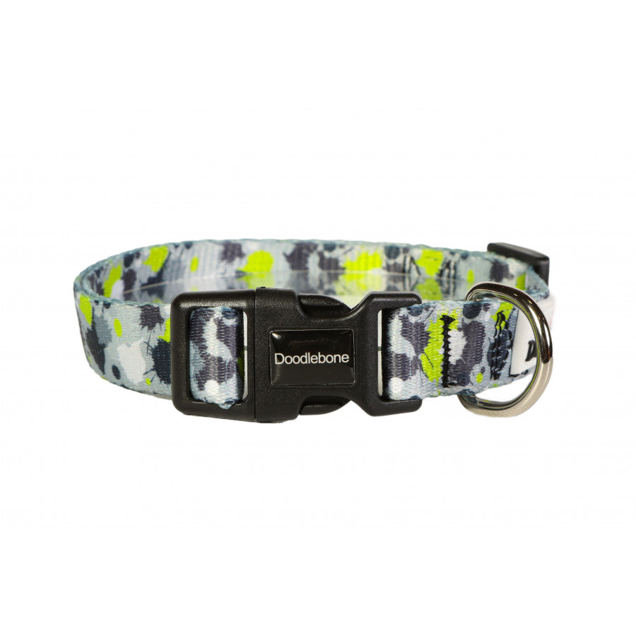 mage shows a lime green, grey, white and black paint splat design dog lead with silver hardwear and the white doodlebone logo