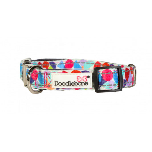 Image shows a bright abstract print dog collar with a mixture of reds, blues, orange and green finished off with  a silver clip and the white doodlebone logo