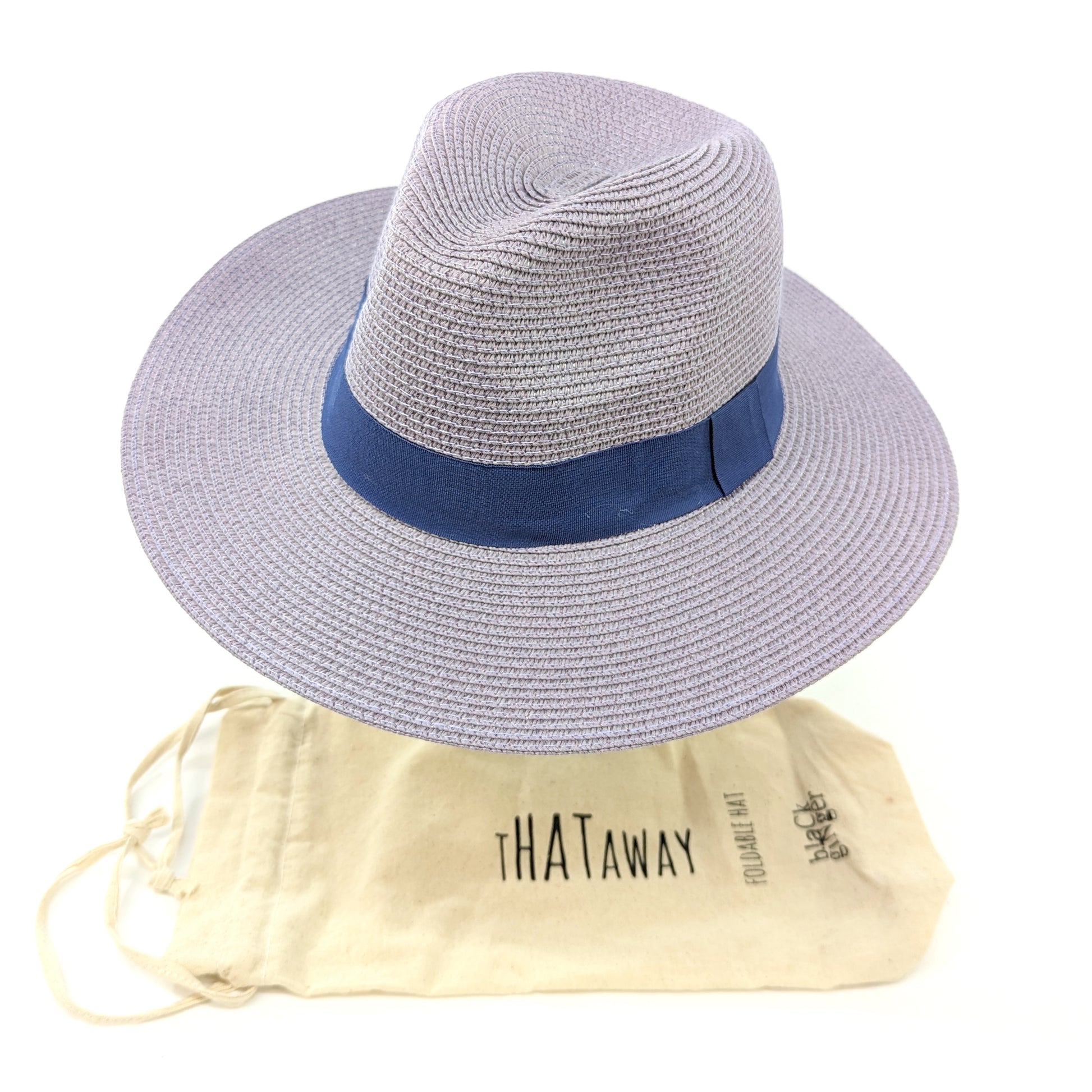 Image shows a lilac panama hat with a dark purple ribbon around the centre