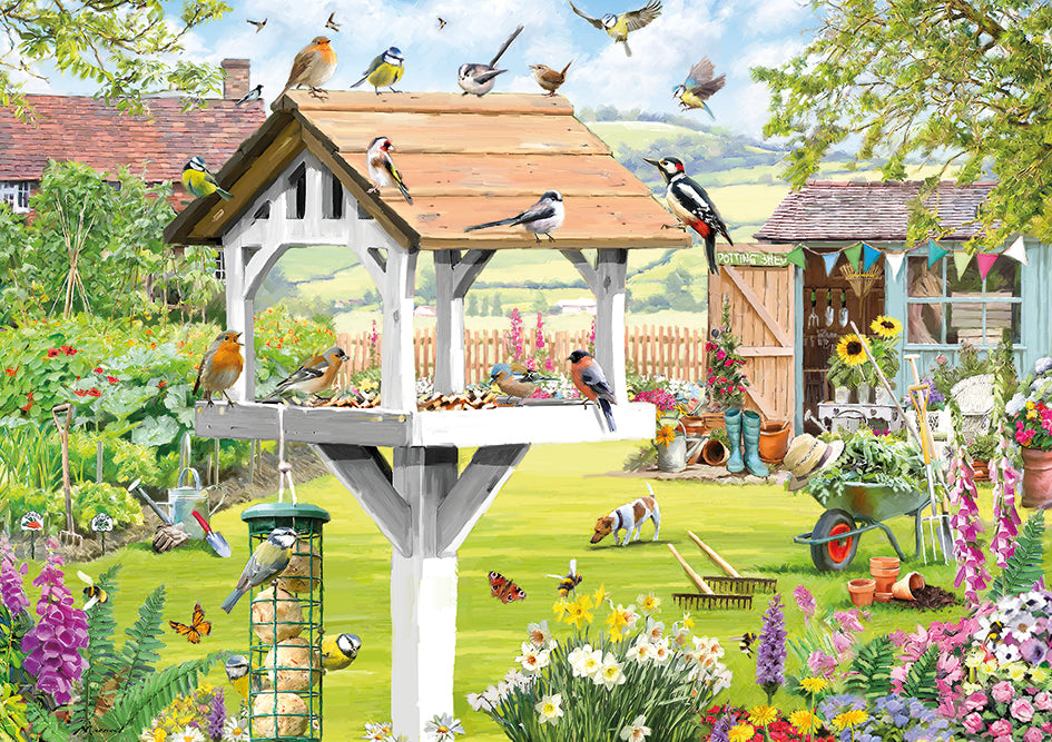 A jigsaw with a beautiful summer garden scene with british birds and a jack russell dog