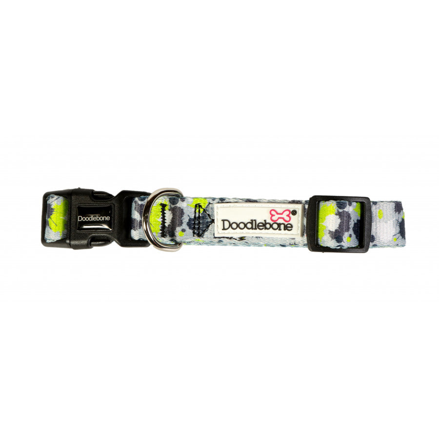 mage shows a lime green, grey, white and black paint splat design dog lead with silver hardwear and the white doodlebone logo