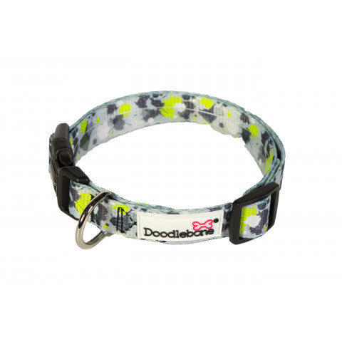 Image shows a lime green, grey, white and black paint splat design dog collar with silver and black hardwear and the white doodlebone logo
