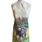 Image shows a cream cotton apron with a beautifully drawn image of our brown Denver the donkey standing in a grassy field