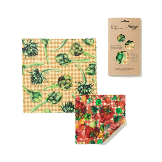 image shows 2 sizes of wax sandwich wraps, one has a yellow and whtie check background with green artichokes amd the other is a red and whtie check background with red, yellow and green tomatos printed 